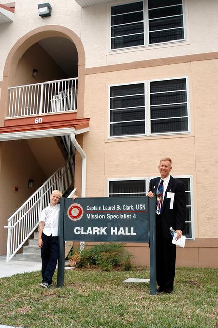 NASA image: KENNEDY SPACE CENTER, FLA. -- Dr. Jonathan Clark (right), husband of STS-107 Mission Specialist Laurel Clark, and their son (left) visit a new residence hall at the Florida Institute of Technology (FIT) in Melbourne, Fla., named for his late wife.  Family members of the STS-107 astronauts, other dignitaries, members of the university community and the public gathered for a dedication ceremony for the Columbia Village at FIT.  Each of the seven new residence halls in the complex is named for one of the STS-107 astronauts who perished during the Columbia accident -- Rick Husband, Willie McCool, Laurel Clark, Michael Anderson, David Brown, Kalpana Chawla, and Ilan Ramon.