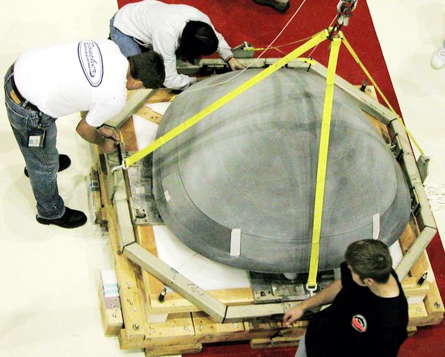 NASA image: KENNEDY SPACE CENTER, FLA. -  In the Orbiter Processing Facility, the nose cap from Atlantis is secured on a shipping pallet.  The reinforced carbon-carbon (RCC) nose cap is being sent to the original manufacturing company, Vought in Ft. Worth, Texas, a subsidiary of Lockheed Martin, to undergo non-destructive testing such as CAT scan and thermography.