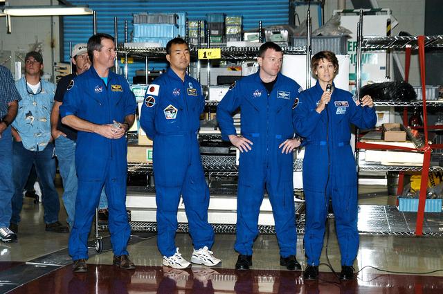 NASA image: KENNEDY SPACE CENTER, FLA. - (From left) STS-114 Mission Specialists Stephen Robinson and Soichi Noguchi, Pilot James Kelly and Commander Eileen Collins talk to workers in the Orbiter Processing Facility. Noguchi is with the Japan Aerospace Exploration Agency, JAXA. The STS-114 crew is at KSC to take part in crew equipment and orbiter familiarization.