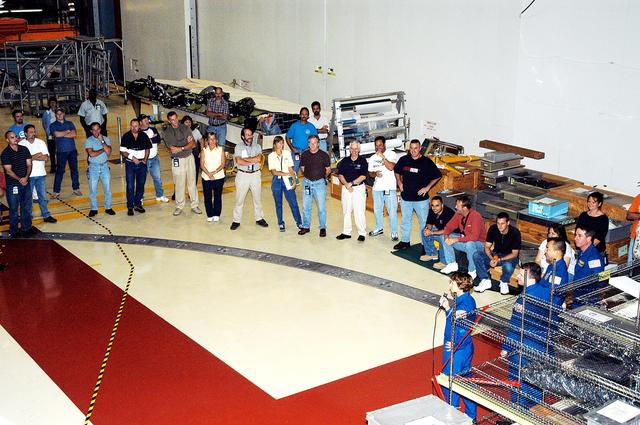NASA image: KENNEDY SPACE CENTER, FLA. - At right, STS-114 Commander Eileen Collins, Pilot James Kelly, and Mission Specialists Soichi Noguchi and Stephen Robinson talk to workers in the Orbiter Processing Facility. Noguchi is with the Japan Aerospace Exploration Agency, JAXA. The STS-114 crew is at KSC to take part in crew equipment and orbiter familiarization.
