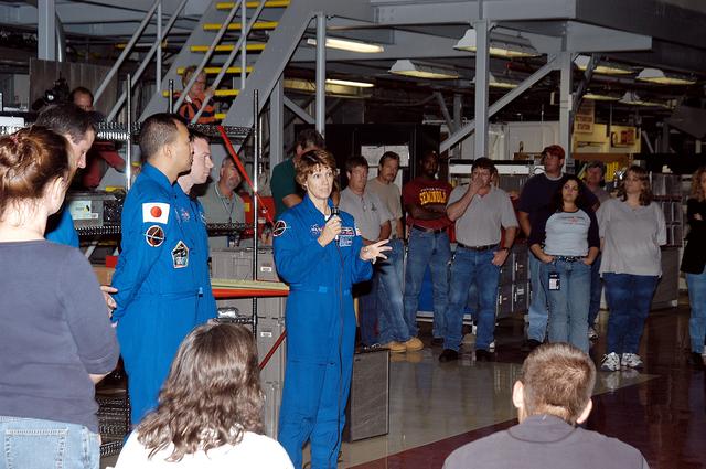 NASA image: KENNEDY SPACE CENTER, FLA. - STS-114 Commander Eileen Collins talk to workers in the Orbiter Processing Facility. With her (at left) are Mission Specialists Stephen Robinson and Soichi Noguchi, and Pilot James Kelly.   Noguchi is with the Japan Aerospace Exploration Agency, JAXA. The STS-114 crew is at KSC to take part in crew equipment and orbiter familiarization.