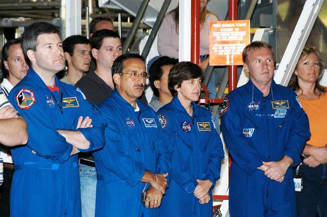 NASA image: KENNEDY SPACE CENTER, FLA. -  While STS-114 Commander Eileen Collins talks to workers in the Orbiter Processing Facility, standing by are (left to right) astronaut Stephen Frick and Mission Specialists Charles Camarda, Wendy Lawrence and Andy Thomas.  Frick is a tile specialist who joined the STS-114 crew during crew equipment and orbiter familiarization at KSC.