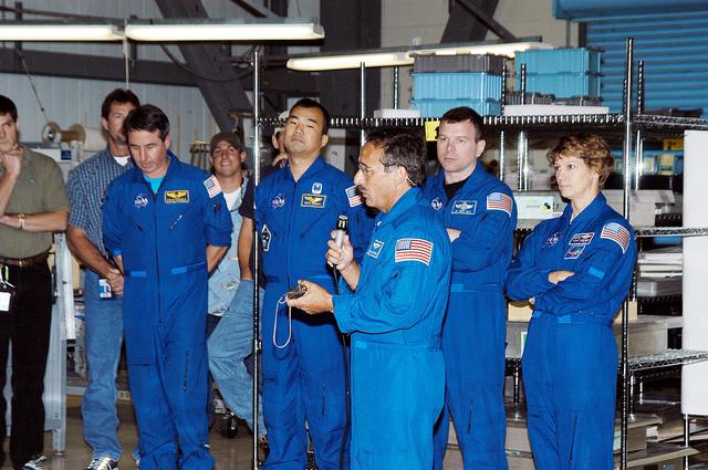NASA image: KENNEDY SPACE CENTER, FLA. -  STS-114 Mission Specialist Charles Camarda talks to workers in the Orbiter Processing Facility.  Behind him (left to right) are other crew members: Mission Specialists Stephen Robinson and Soichi Noguchi, Pilot James Kelly and Commander Eileen Collins.  Camarda is a new addition to the crew.  Noguchi is with the Japan Aerospace Exploration Agency, JAXA.  The STS-114 crew is at KSC to take part in crew equipment and orbiter familiarization.