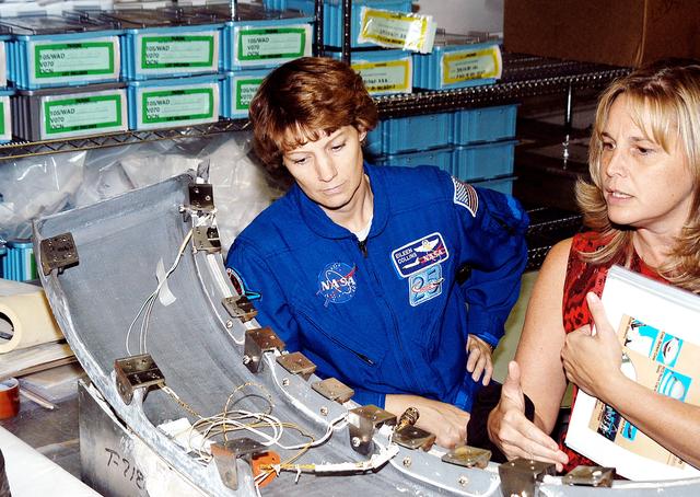 NASA image: KENNEDY SPACE CENTER, FLA. - STS-114 Mission Commander Eileen Collins looks over flight equipment in the Orbiter Processing Facility, along with Glenda Laws, EVA Task Leader, with United Space Alliance at Johnson Space Center. The STS-114 crew is at KSC to take part in crew equipment and orbiter familiarization.