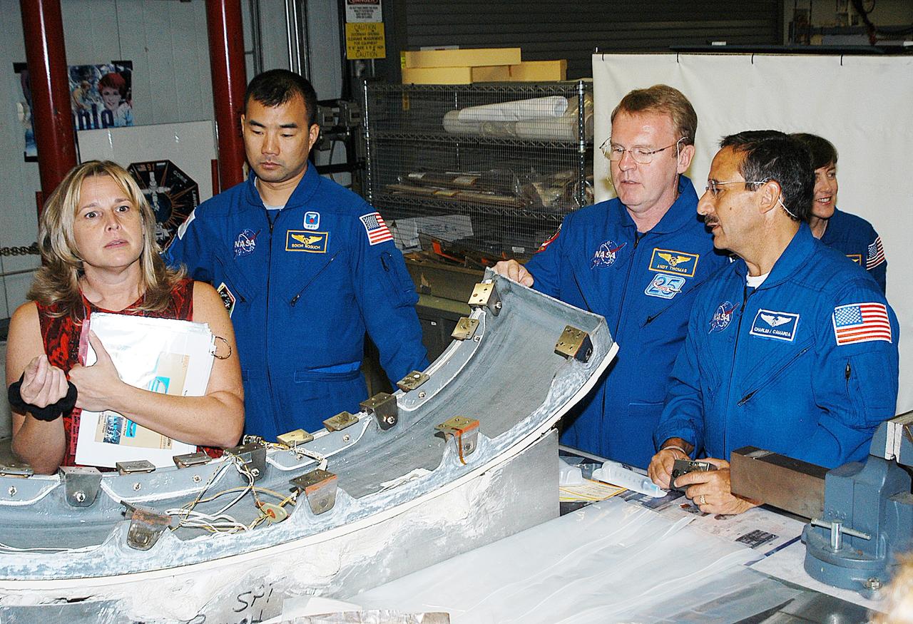 KENNEDY SPACE CENTER, FLA. - Members of the STS-114 crew look over flight  equipment in the Orbiter Processing Facility.  From left are Glenda Laws, EVA Task Leader, with United Space Alliance at Johnson Space Center, Mission Specialists Soichi Noguchi, Andy Thomas, Charles Camarda and Wendy Lawrence. Noguchi is with the Japan Aerospace Exploration Agency, JAXA.  Not seen are Mission Commander Eileen Collins, Pilot James Kelly and Mission Specialist Stephen Robinson. The STS-114 crew is at KSC to take part in crew equipment and orbiter familiarization.