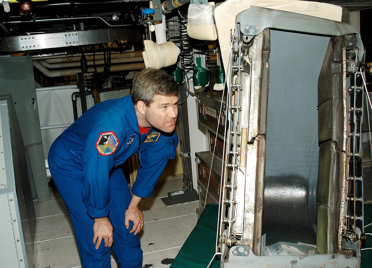 KENNEDY SPACE CENTER, FLA. -   Astronaut Stephen Frick takes a close look at a reinforced carbon-carbon panel to be installed on orbiter Atlantis.  Frick is a tile specialist, who joined the STS-114 crew during crew equipment and orbiter familiarization in the Orbiter Processing Facility.