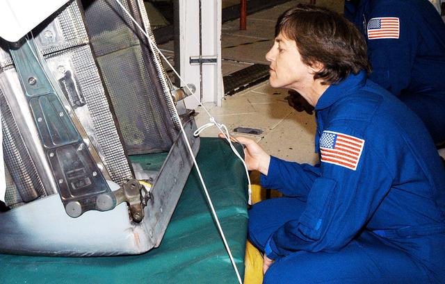 NASA image: KENNEDY SPACE CENTER, FLA. -   In the Orbiter Processing Facility, STS-114 Mission Specialist Wendy Lawrence looks at an reinforced carbon-carbon panel ready to be installed on Atlantis.  Lawrence is a new addition to the mission crew, who are at KSC to take part in crew equipment and orbiter familiarization.