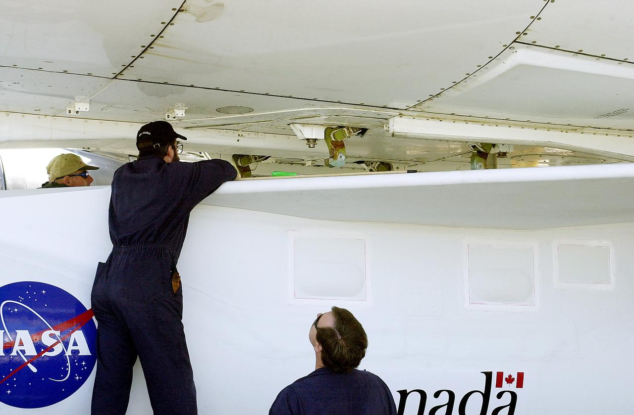 VANDENBERG AIR FORCE BASE, CALIF. -    Workers mate the Pegasus , with its cargo of the SciSat-1 payload to the L-1011 carrier aircraft.  The SciSat-1 weighs approximately 330 pounds and after launch will be placed in a 400-mile-high polar orbit to investigate processes that control the distribution of ozone in the upper atmosphere. The data from the satellite will provide Canadian and international scientists with improved measurements relating to global ozone processes and help policymakers assess existing environmental policy and develop protective measures for improving the health of our atmosphere, preventing further ozone depletion. The mission is designed to last two years.