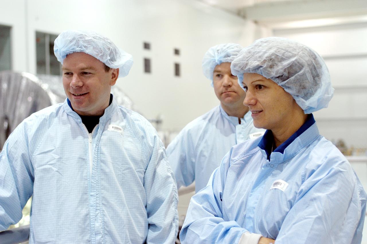 KENNEDY SPACE CENTER, FLA. - In the Space Station Processing Facility, STS-114 Pilot James Kelly (left) and Commander Eileen Collins look at various equipment housed there.  The STS-114 crew is at KSC to take part in crew equipment and orbiter familiarization.