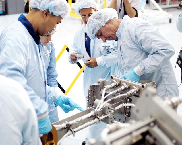 NASA image: KENNEDY SPACE CENTER, FLA. - In the Space Station Processing Facility, STS-114 crew members get hands-on experience with a Video Stanchion Support Assembly (VSSA).  From left are Mission Specialist Soichi Noguchi, Commander Eileen Collins and Mission Specialists Charles Camarda and Stephen Robinson.  Noguchi is with the Japan Aerospace Exploration Agency, JAXA.  Camarda is a new addition to the mission crew. The STS-114 crew is at KSC to take part in crew equipment and orbiter familiarization.