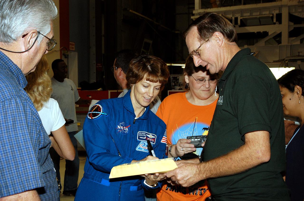 KENNEDY SPACE CENTER, FLA. - STS-114 Mission Commander Eileen Collins signs autorgraphs for workers in the Orbiter Processing Facility.   The STS-114 crew is at KSC to take part in crew equipment and orbiter familiarization.