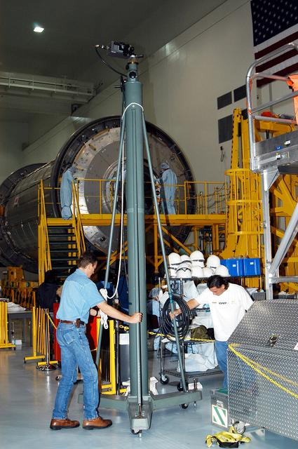 NASA image: KENNEDY SPACE CENTER, FLA. - In the Space Station Processing Facility, technicians with The Boeing Company move an infrared camera into position near the Japanese Experiment Module (JEM) for pre-assembly measurements.  Developed by the Japan Aerospace Exploration Agency (JAXA), the JEM will enhance the unique research capabilities of the orbiting complex by providing an additional environment for astronauts to conduct science experiments.