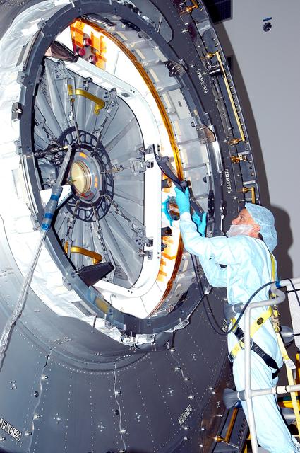 NASA image: KENNEDY SPACE CENTER, FLA. - In the Space Station Processing Facility, a technician takes readings for pre-assembly measurements on the Japanese Experiment Module (JEM).  Developed by the Japan Aerospace Exploration Agency (JAXA), the JEM will enhance the unique research capabilities of the orbiting complex by providing an additional environment for astronauts to conduct science experiments.