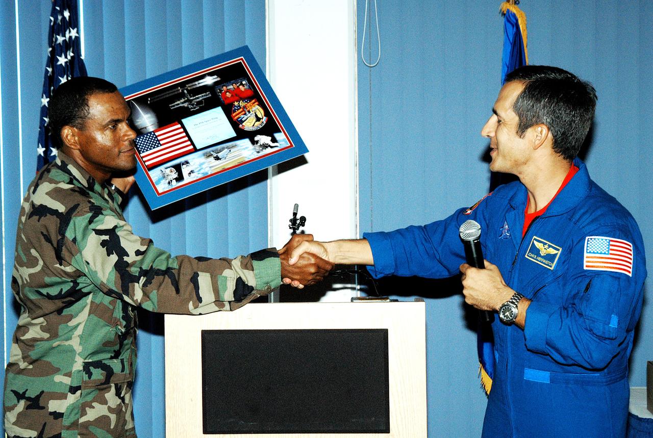 KENNEDY SPACE CENTER, FLA. -  Col. Everett Thomas (left), 45th Space Wing, presents a framed memento to astronaut John Herrington during a luncheon celebrating Native American Heritage Month held at the Patrick Air Force Base NCO Club.  Herrington is a tribally enrolled Chickasaw and the world’s first Native American astronaut, who last flew on mission STS-113 in 2002.