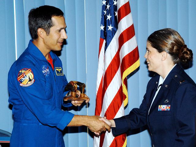 NASA image: KENNEDY SPACE CENTER, FLA. - Astronaut John Herrington (left) accepts a carved sculpture from 2nd Lt. Bernice Zollner, 45th Space Wing, during a luncheon celebrating Native American Heritage Month held at the Patrick Air Force Base NCO Club. Zollner was emcee of the event.  Herrington is a tribally enrolled Chickasaw and the world’s first Native American astronaut, who last flew on mission STS-113 in 2002.
