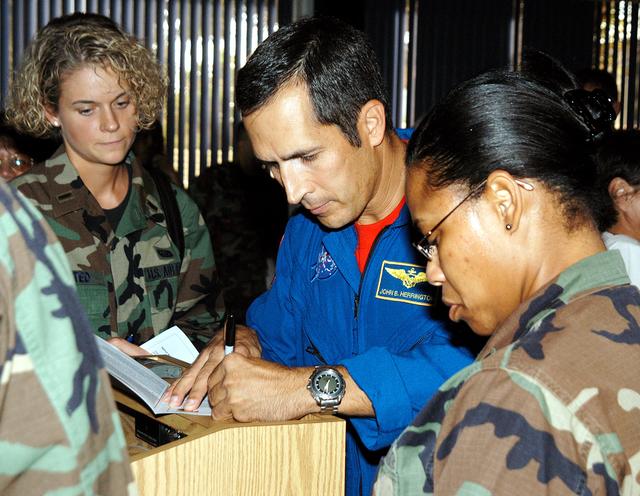 NASA image: KENNEDY SPACE CENTER, FLA. -  After a luncheon celebrating Native American Heritage Month held at the Patrick Air Force Base NCO Club, astronaut John Herrington signs autographs for invited guests.  Herrington is a tribally enrolled Chickasaw and the world’s first Native American astronaut, who last flew on mission STS-113 in 2002.