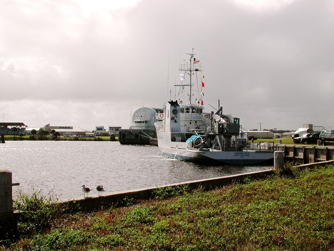 KENNEDY SPACE CENTER, FLA. - The Freedom Star is berthed at the Turn Basin near the Vehicle Assembly Building.  The ship has recently returned to KSC after refurbishment at Fort George Island, Fla., including new paint.  Freedom Star is one of the solid rocket booster (SRB) retrieval ships built to recover the SRB casings released over the Atlantic Ocean after launch of a Space Shuttle.  In addition to the SRBs, the ship recovers the drogue and main parachutes that slow the boosters’ speed before splashdown.  Some of the retrieval equipment can be seen on the rear deck.  The ships also tow the external tanks built at the Michoud Space Systems Assembly Facility near New Orleans to Port Canaveral, Fla.  Freedom Star was brought to KSC today for a visit by NATO Parliamentarians.