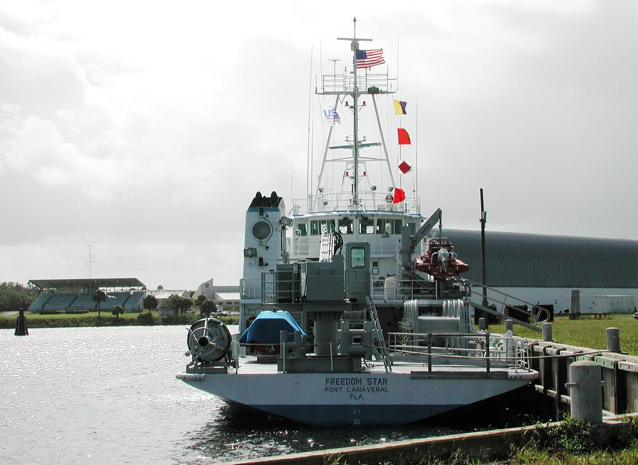 KENNEDY SPACE CENTER, FLA. - The Freedom Star is berthed at the Turn Basin near the Vehicle Assembly Building.  The ship has recently returned to KSC after refurbishment at Fort George Island, Fla., including new paint.  Freedom Star is one of the solid rocket booster (SRB) retrieval ships built to recover the SRB casings released over the Atlantic Ocean after launch of a Space Shuttle.  In addition to the SRBs, the ship recovers the drogue and main parachutes that slow the boosters’ speed before splashdown.  Some of the retrieval equipment can be seen on the rear deck.  The ships also tow the external tanks built at the Michoud Space Systems Assembly Facility near New Orleans to Port Canaveral, Fla.  Freedom Star was brought to KSC today for a visit by NATO Parliamentarians.