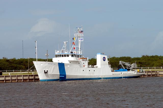 NASA image: KENNEDY SPACE CENTER, FLA. - The Freedom Star is berthed at the Turn Basin near the Vehicle Assembly Building.  The ship has recently returned to KSC after refurbishment at Fort George Island, Fla., including new paint.  Freedom Star is one of the solid rocket booster (SRB) retrieval ships built to recover the SRB casings released over the Atlantic Ocean after launch of a Space Shuttle.  In addition to the SRBs, the ship recovers the drogue and main parachutes that slow the boosters’ speed before splashdown.  The ships also tow the external tanks built at the Michoud Space Systems Assembly Facility near New Orleans to Port Canaveral, Fla.  Freedom Star was brought to KSC today for a visit by NATO Parliamentarians.