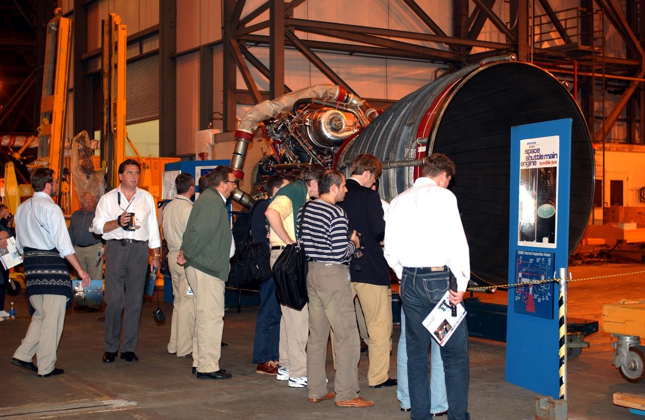 KENNEDY SPACE CENTER, FLA. - Members of the North American Treaty Organization (NATO) Parliamentary Assembly  get a close look at a Space Shuttle main engine in the Vehicle Assembly Building during their tour of KSC.   The Parliamentarians are meeting in Orlando this year for their 49th annual gathering.  They chose to visit KSC with their families during their one-day excursion break from meetings.