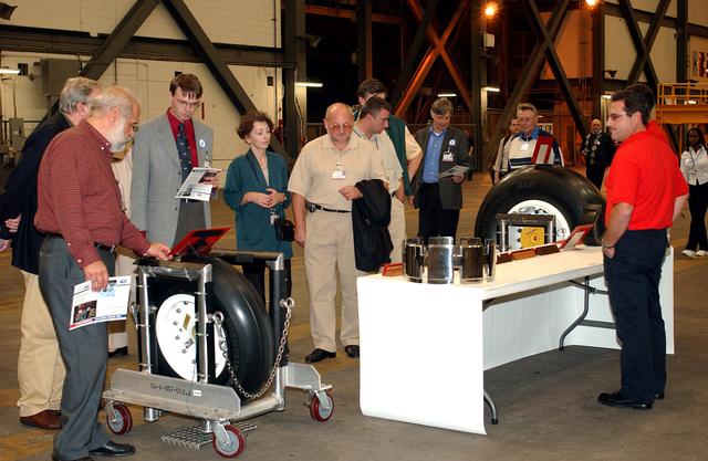 KENNEDY SPACE CENTER, FLA. - During their tour of KSC, members of the North American Treaty Organization (NATO) Parliamentary Assembly get a close look at wheels used on an orbiter.  The Parliamentarians are meeting in Orlando this year for their 49th annual gathering.  They chose to visit KSC with their families during their one-day excursion break from meetings.
