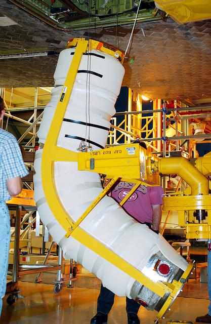 NASA image: KENNEDY SPACE CENTER, FLA. -   In the Orbiter Processing Facility, workers raise the liquid oxygen feedline for the 17-inch disconnect toward orbiter Discovery for installation. The 17-inch liquid oxygen and liquid hydrogen disconnects provide the propellant feed interface from the external tank to the orbiter main propulsion system and the three Shuttle main engines.