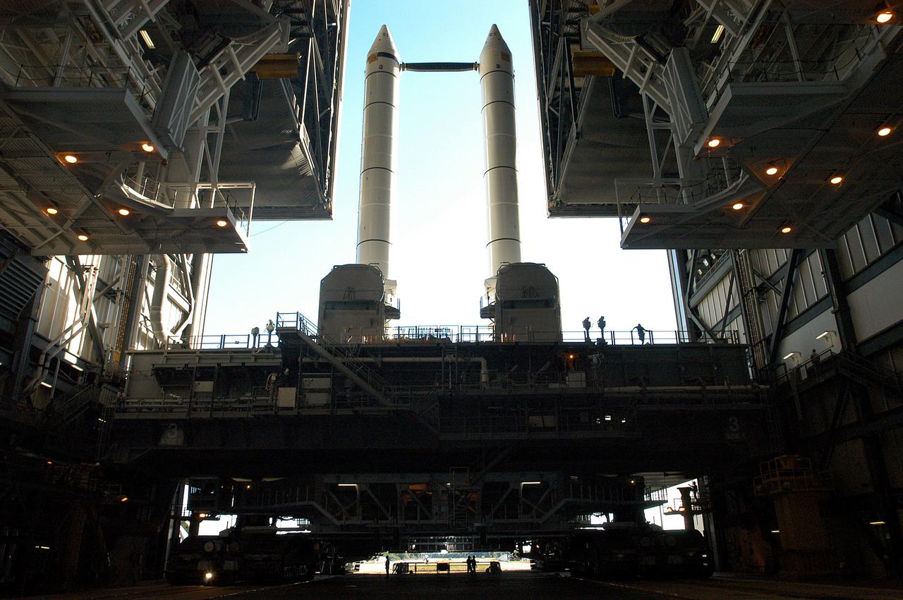 KENNEDY SPACE CENTER, FLA. -   The crawler transporter is slowly moving the Mobile Launcher Platform (MLP), carrying a set of twin solid rocket boosters, out of the Vehicle Assembly Building (VAB) in support of engineering analysis vibration tests on the crawler and MLP. The crawler is moving at various speeds up to 1 mph in an effort to achieve vibration data gathering goals as it leaves the VAB and then returns.  The boosters are braced at the top for stability.  The primary purpose of these rollout tests is to gather data to develop future maintenance requirements on the transport equipment and the flight hardware. Various parts of the MLP and crawler transporter have been instrumented with vibration data collection equipment.