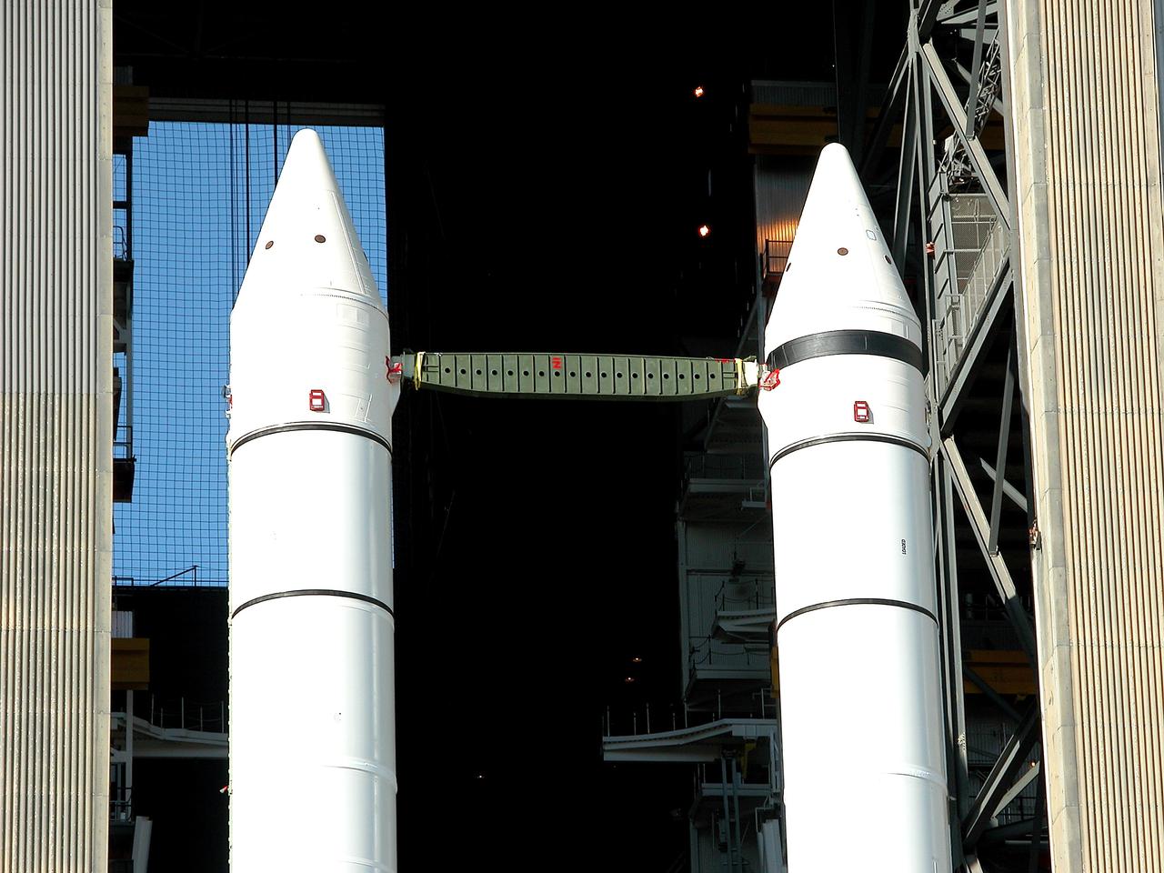 KENNEDY SPACE CENTER, FLA. -  As the crawler transporter slowly moves the Mobile Launcher Platform (MLP) out of the Vehicle Assembly Building, the two solid rocket boosters on top are framed in the doorway.  The move is in support of engineering analysis vibration tests on the crawler and MLP.  The crawler is moving at various speeds up to 1 mph in an effort to achieve vibration data gathering goals as it leaves the VAB and then returns.  The boosters are braced at the top for stability.  The primary purpose of these rollout tests is to gather data to develop future maintenance requirements on the transport equipment and the flight hardware. Various parts of the MLP and crawler transporter have been instrumented with vibration data collection equipment.