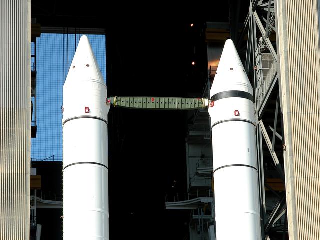 NASA image: KENNEDY SPACE CENTER, FLA. -  As the crawler transporter slowly moves the Mobile Launcher Platform (MLP) out of the Vehicle Assembly Building, the two solid rocket boosters on top are framed in the doorway.  The move is in support of engineering analysis vibration tests on the crawler and MLP.  The crawler is moving at various speeds up to 1 mph in an effort to achieve vibration data gathering goals as it leaves the VAB and then returns.  The boosters are braced at the top for stability.  The primary purpose of these rollout tests is to gather data to develop future maintenance requirements on the transport equipment and the flight hardware. Various parts of the MLP and crawler transporter have been instrumented with vibration data collection equipment.