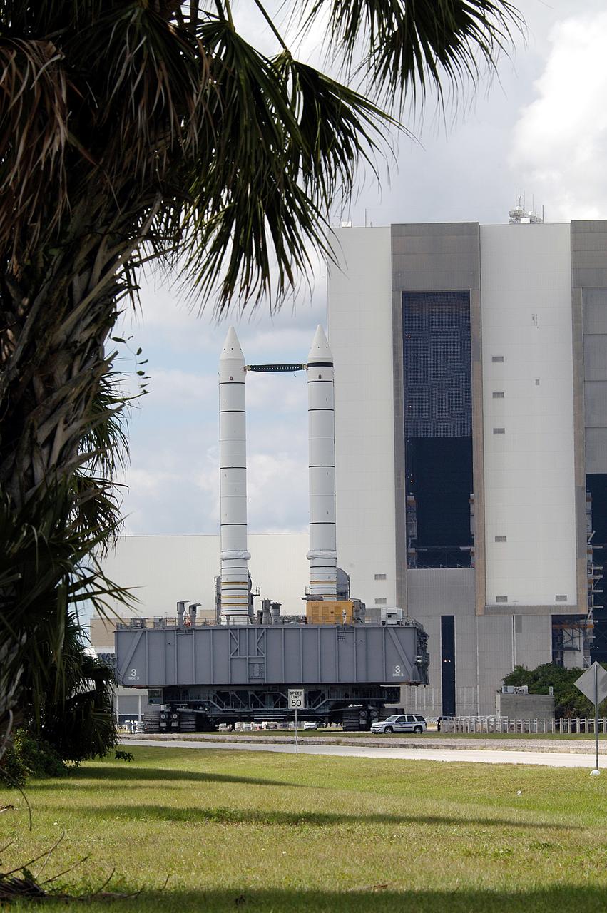KENNEDY SPACE CENTER, FLA. -  Mobile Launcher Platform (MLP) number 3 and a set of twin solid rocket boosters, atop the crawler-transporter, crawls away from the Vehicle Assembly Building in support of the second engineering analysis vibration test on the crawler and MLP. The crawler is moving at various speeds up to 1 mph in an effort to achieve vibration data gathering goals as it leaves the VAB, travels toward Launch Pad 39A and then returns.  The boosters are braced at the top for stability.  The primary purpose of these rollout tests is to gather data to develop future maintenance requirements on the transport equipment and the flight hardware. Various parts of the MLP and crawler transporter have been instrumented with vibration data collection equipment.