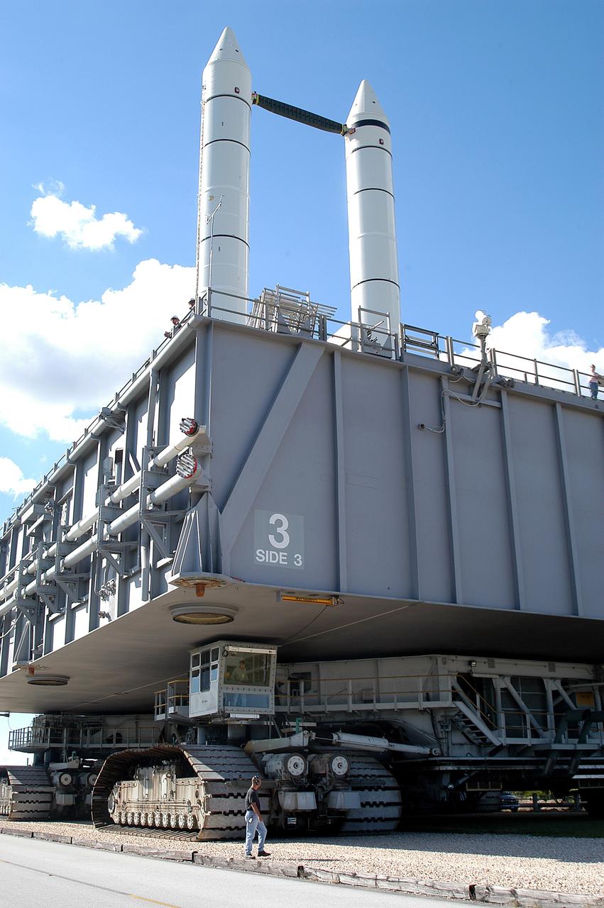 KENNEDY SPACE CENTER, FLA. - A Kennedy Space Center technician monitors the performance of a crawler-transporter as it moves Mobile Launcher Platform (MLP) number 3, with a set of twin solid rocket boosters bolted atop, to the intersection in the crawlerway during the second engineering analysis vibration test on the crawler and MLP.  The crawler is moving at various speeds up to 1 mph in an effort to achieve vibration data gathering goals as it leaves the VAB, travels toward Launch Pad 39A, and then returns. The boosters are braced at the top for stability. The primary purpose of these rollout tests is to gather data to develop future maintenance requirements on the transport equipment and the flight hardware. Various parts of the MLP and crawler transporter have been instrumented with vibration data collection equipment.
