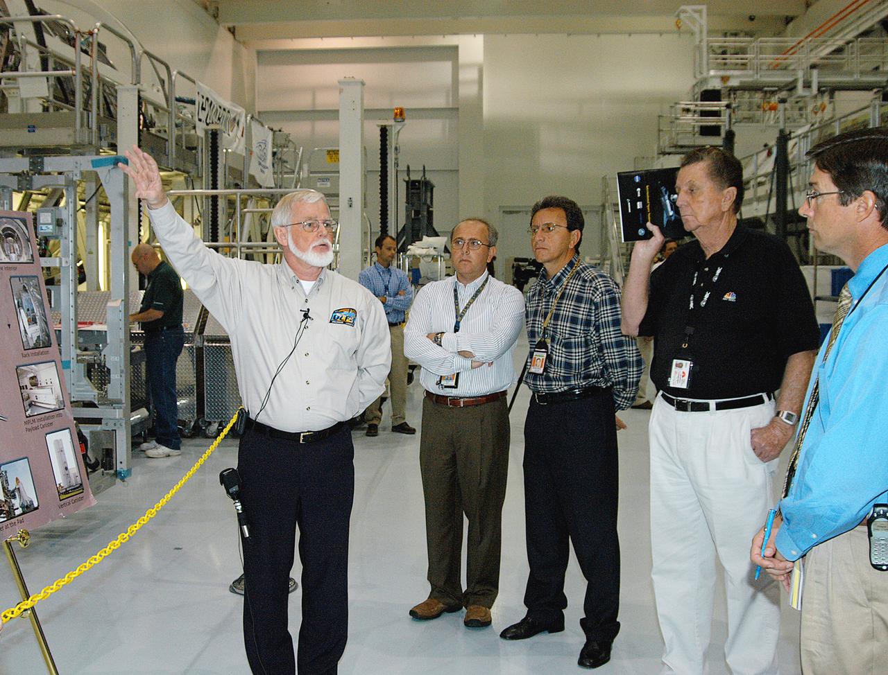 In the Space Station Processing Facility (SSPF), Jeff Traylor, with The Boeing Co., talks to the media about the Multi-Purpose Logistics Modules, reusable logistics carriers used on missions to the International Space Station. To commemorate the fifth anniversary of the launch of the first element of the International Space Station, the media were invited to tour the SSPF at KSC. Reporters had the opportunity to see Space Station hardware that is being processed for deployment once the Space Shuttles return to flight as well as talk with NASA and Boeing mission managers about the various hardware elements currently being processed for flight.