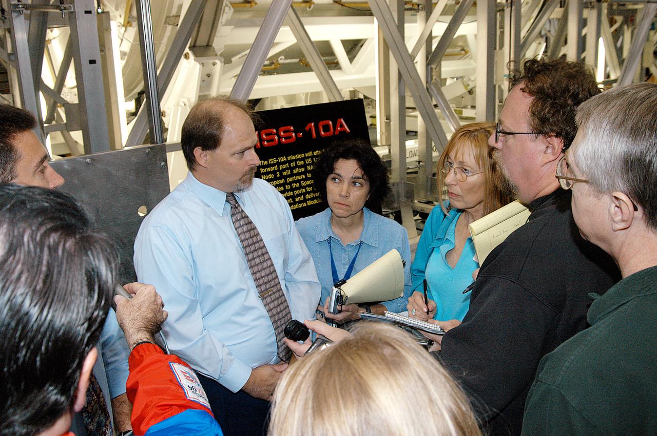 In the Space Station Processing Facility (SSPF), all eyes are on Richard Kuhns, NASA Node 2/10A Mission Integration Engineer, International Space Station and Payload Processing, as he discusses the Node 2 with members of the media. The installation of NASA's Node 2 denotes the U.S. Core Complete stage of International Space Station assembly and, among other functions, will provide a passageway between four Station science experiment facilities: the U.S. Destiny Laboratory, the Kibo Japanese Experiment Module, the European Columbus Laboratory and the Centrifuge Accommodation Module. Reporters were invited to commemorate the fifth anniversary of the launch of the first element of the Station with a tour of the SSPF and had the opportunity to see Space Station hardware that is being processed for deployment once the Space Shuttles return to flight. NASA and Boeing mission managers were on hand to talk about the various hardware elements currently being processed for flight.