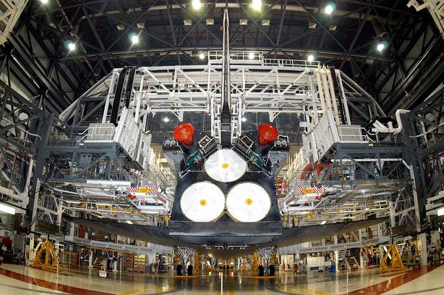 NASA image: KENNEDY SPACE CENTER, FLA. - The Space Shuttle orbiter Atlantis awaits transport from the Orbiter Processing Facility (OPF) to the Vehicle Assembly Building (VAB). The move will allow work to be performed in the OPF that can only be accomplished while the bay is empty. Work scheduled in the processing facility includes annual validation of the bay's cranes, work platforms, lifting mechanisms, and jack stands. Atlantis will remain in the VAB for about 10 days, then return to the OPF as work resumes to prepare it for launch in September 2004 on the first return-to-flight mission, STS-114.