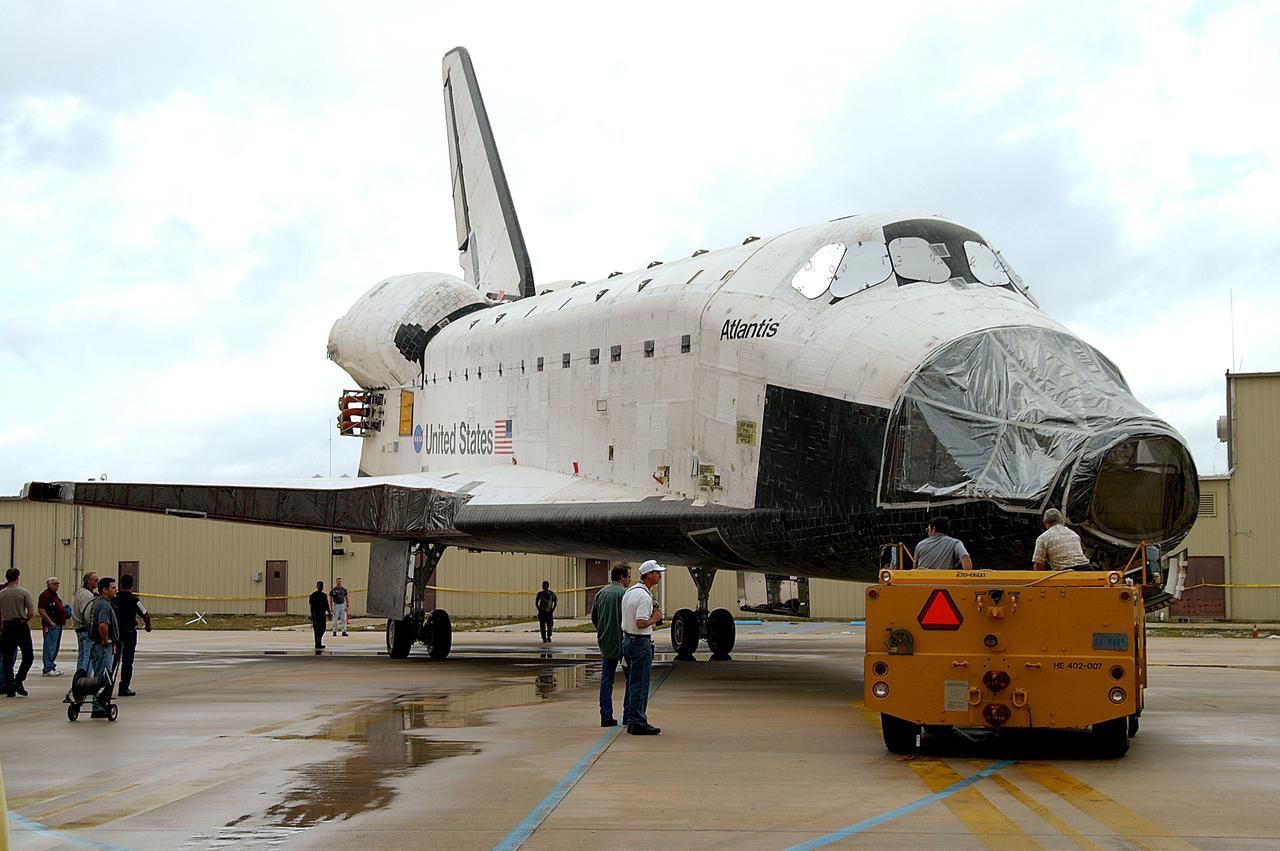 KENNEDY SPACE CENTER, FLA. - The Space Shuttle orbiter Atlantis is turned into position outside the Orbiter Processing Facility (OPF) for its tow to the Vehicle Assembly Building (VAB). The move will allow work to be performed in the OPF that can only be accomplished while the bay is empty. Work scheduled in the processing facility includes annual validation of the bay's cranes, work platforms, lifting mechanisms, and jack stands. Atlantis will remain in the VAB for about 10 days, then return to the OPF as work resumes to prepare it for launch in September 2004 on the first return-to-flight mission, STS-114.