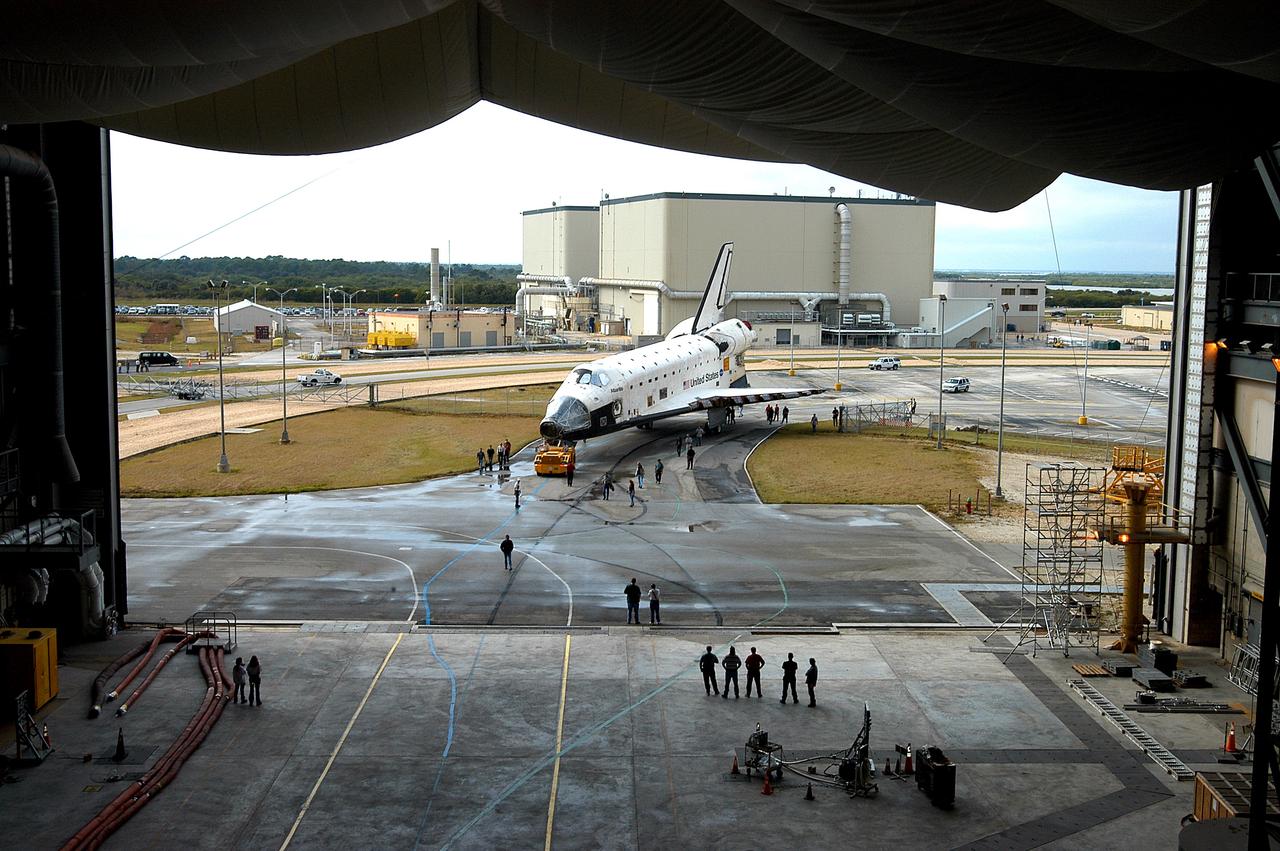KENNEDY SPACE CENTER, FLA. - The Space Shuttle orbiter Atlantis approaches high bay 4 of the Vehicle Assembly Building (VAB).  It was towed from the Orbiter Processing Facility (OPF) to allow work to be performed in the bay that can only be accomplished while it is empty. Work scheduled in the processing facility includes annual validation of the bay's cranes, work platforms, lifting mechanisms, and jack stands. Atlantis will remain in the VAB for about 10 days, then return to the OPF as work resumes to prepare it for launch in September 2004 on the first return-to-flight mission, STS-114.