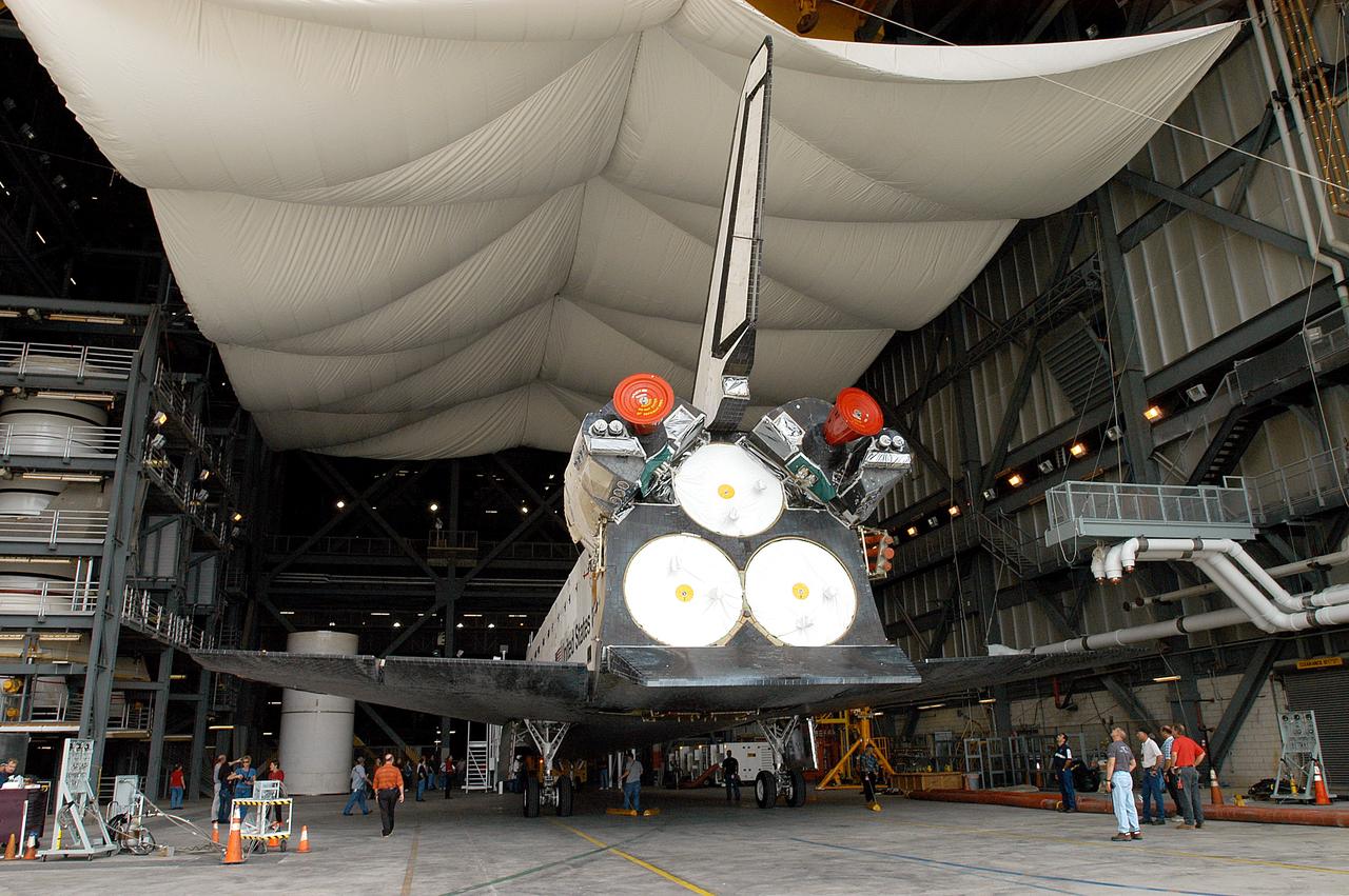 KENNEDY SPACE CENTER, FLA. - The Space Shuttle orbiter Atlantis arrives in high bay 4 of the Vehicle Assembly Building (VAB).  It was towed from the Orbiter Processing Facility (OPF) to allow work to be performed in the bay that can only be accomplished while it is empty. Work scheduled in the processing facility includes annual validation of the bay's cranes, work platforms, lifting mechanisms, and jack stands. Atlantis will remain in the VAB for about 10 days, then return to the OPF as work resumes to prepare it for launch in September 2004 on the first return-to-flight mission, STS-114.
