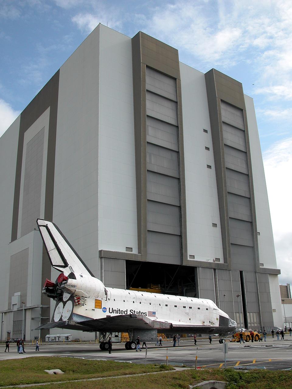 KENNEDY SPACE CENTER, FLA. - The Space Shuttle orbiter Atlantis approaches the Vehicle Assembly Building (VAB) high bay 4.  It is being towed from the Orbiter Processing Facility (OPF) to allow work to be performed in the bay that can only be accomplished while it is empty. Work scheduled in the processing facility includes annual validation of the bay's cranes, work platforms, lifting mechanisms, and jack stands. Atlantis will remain in the VAB for about 10 days, then return to the OPF as work resumes to prepare it for launch in September 2004 on the first return-to-flight mission, STS-114.