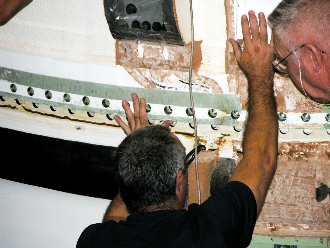 KENNEDY SPACE CENTER, FLA. -  In the Vehicle Assembly Building, a KSC employee separates the forward assembly (nose cap and frustum) from a solid rocket booster (SRB) after removing the bolts.  The destacking is part of time and cycle activities.  The SRB was part of the stack on Atlantis originally scheduled for a March 1, 2003, launch on mission STS-114.  The SRBs and external tank were demated in February 2003.   The mission is now scheduled to occur no earlier than Sept. 12, 2004, on Atlantis.