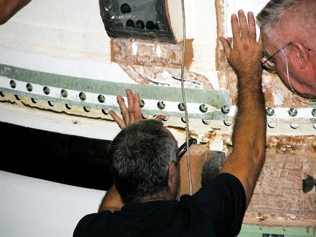 KENNEDY SPACE CENTER, FLA. -  In the Vehicle Assembly Building, a KSC employee separates the forward assembly (nose cap and frustum) from a solid rocket booster (SRB) after removing the bolts.  The destacking is part of time and cycle activities.  The SRB was part of the stack on Atlantis originally scheduled for a March 1, 2003, launch on mission STS-114.  The SRBs and external tank were demated in February 2003.   The mission is now scheduled to occur no earlier than Sept. 12, 2004, on Atlantis.