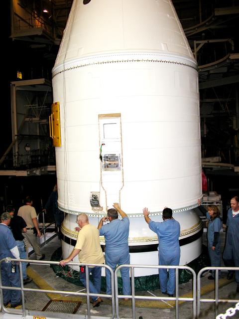KENNEDY SPACE CENTER, FLA. -  In the Vehicle Assembly Building, KSC employees help guide the destacking of the forward assembly (nose cap and frustum) from a solid rocket booster (SRB) after the bolts were removedThe destacking is part of time and cycle activities.  The SRB was part of the stack on Atlantis originally scheduled for a March 1, 2003, launch on mission STS-114.  The SRBs and external tank were demated in February 2003.   The mission is now scheduled to occur no earlier than Sept. 12, 2004, on Atlantis.