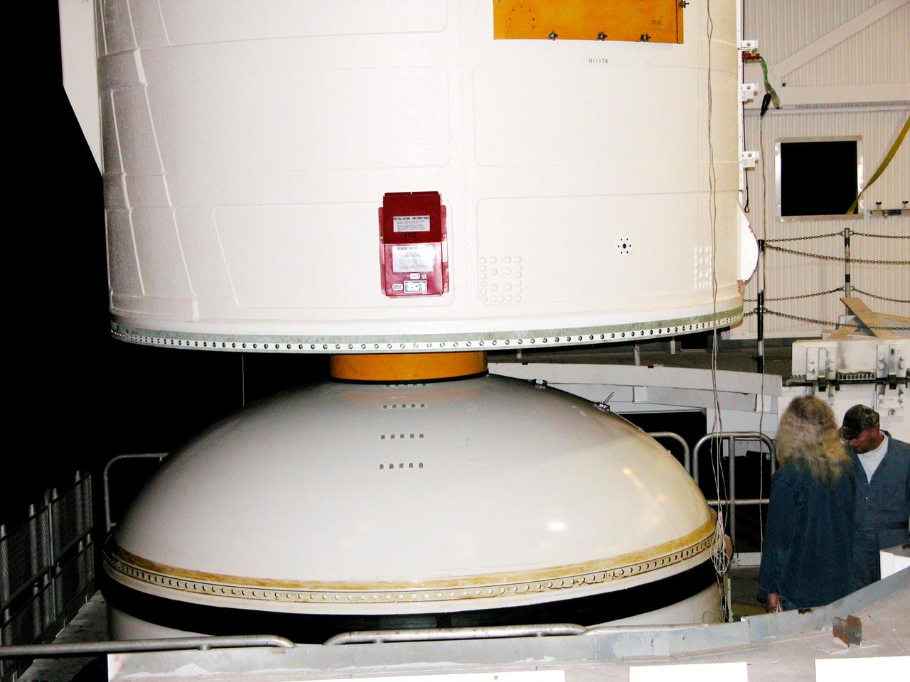 KENNEDY SPACE CENTER, FLA. -  In the Vehicle Assembly Building, the forward assembly (nose cap and frustum) is moved away from the solid rocket booster (SRB).  The destacking is part of time and cycle activities.  The SRB was part of the stack on Atlantis originally scheduled for a March 1, 2003, launch on mission STS-114.  The SRBs and external tank were demated in February 2003.   The mission is now scheduled to occur no earlier than Sept. 12, 2004, on Atlantis.