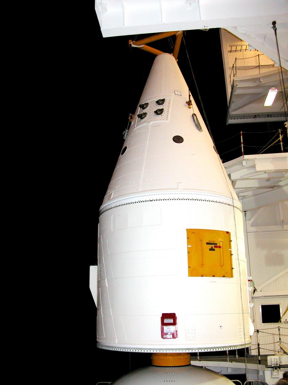 KENNEDY SPACE CENTER, FLA. -  In the Vehicle Assembly Building, the forward assembly (nose cap and frustum) is lifted away from the solid rocket booster (SRBThe destacking is part of time and cycle activities.  The SRB was part of the stack on Atlantis originally scheduled for a March 1, 2003, launch on mission STS-114.  The SRBs and external tank were demated in February 2003.   The mission is now scheduled to occur no earlier than Sept. 12, 2004, on Atlantis.