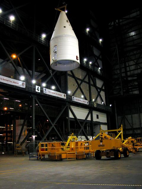 KENNEDY SPACE CENTER, FLA. -  In the Vehicle Assembly Building, after being removed from the solid rocket booster (SRB), the forward assembly is lowered toward a transporter below in the transfer aisle.  The destacking is part of time and cycle activities.  The SRB was part of the stack on Atlantis originally scheduled for a March 1, 2003, launch on mission STS-114.  The SRBs and external tank were demated in February 2003.   The mission is now scheduled to occur no earlier than Sept. 12, 2004, on Atlantis.