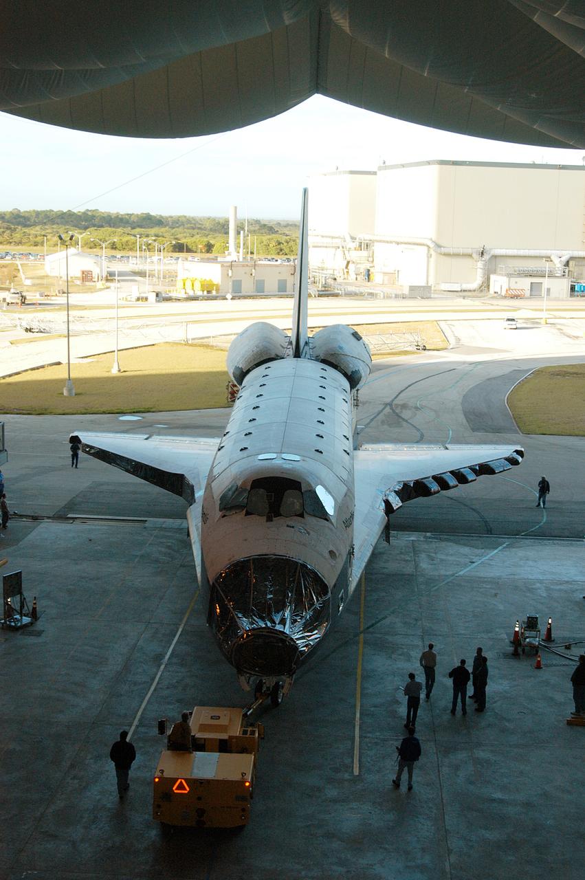 KENNEDY SPACE CENTER, FLA. -- The orbiter Atlantis is backed out of the Vehicle Assembly Building for transfer back to the Orbiter Processing Facility.  Atlantis spent 10 days in the VAB to allow work to be performed in the OPF that can only be accomplished while the bay is empty. Work included annual validation of the bay's cranes, work platforms, lifting mechanisms and jack stands.  Work resumes to prepare Atlantis for launch in September 2004 on the first return-to-flight mission, STS-114.