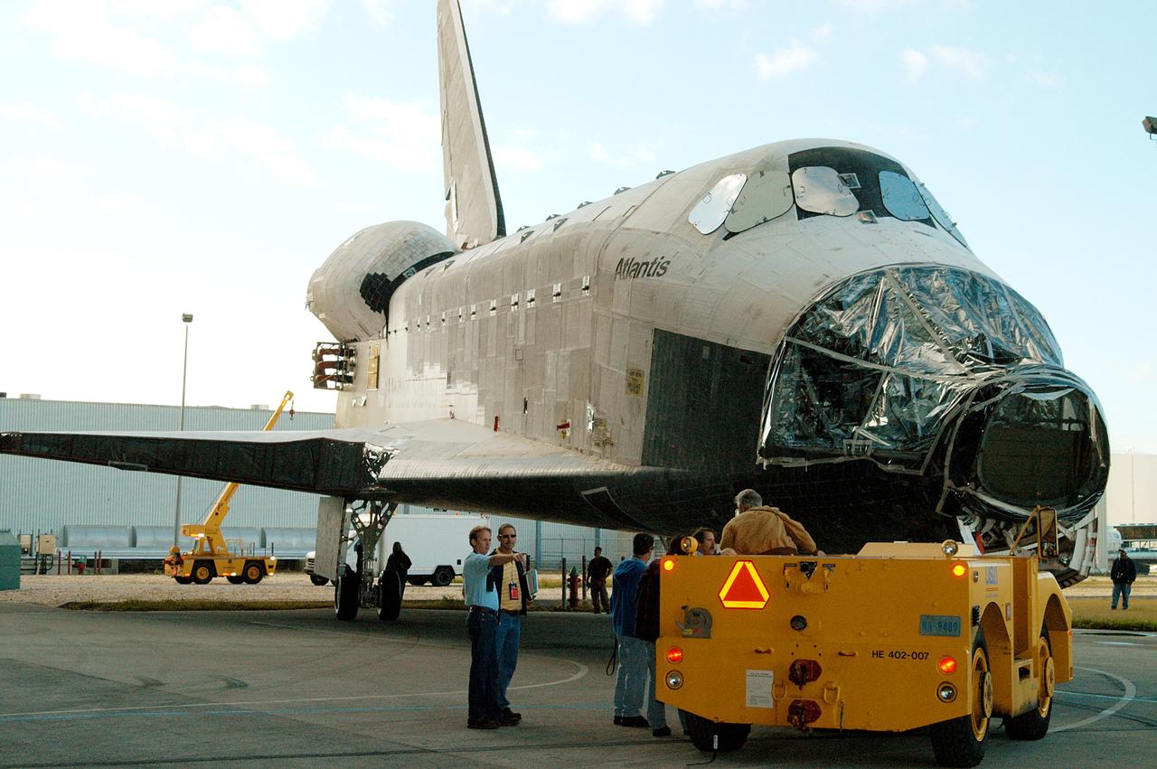 KENNEDY SPACE CENTER, FLA. -  The orbiter Atlantis is backed out of the Vehicle Assembly Building for transfer back to the Orbiter Processing Facility.  Atlantis spent 10 days in the VAB to allow work to be performed in the OPF that can only be accomplished while the bay is empty. Work included annual validation of the bay's cranes, work platforms, lifting mechanisms and jack stands.  Work resumes to prepare Atlantis for launch in September 2004 on the first return-to-flight mission, STS-114.