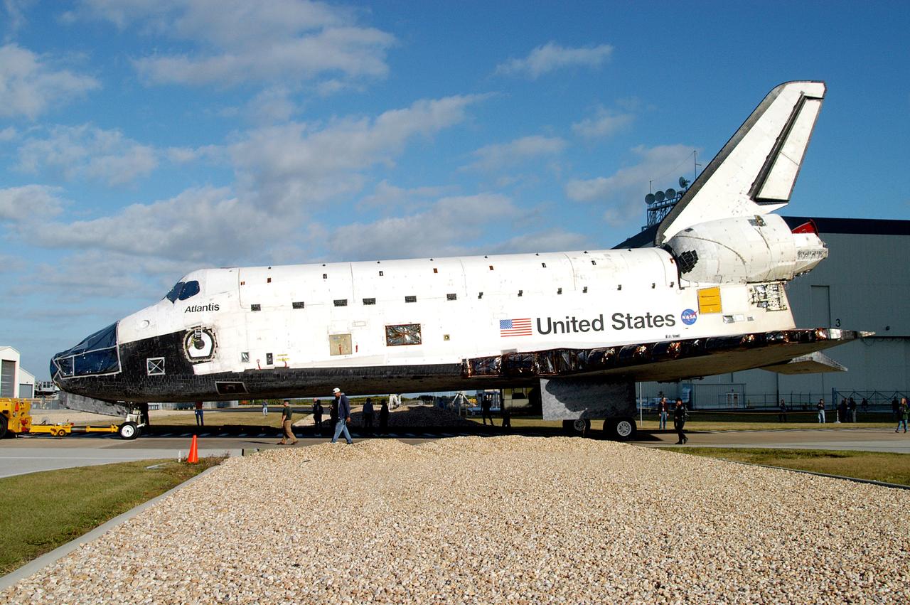 KENNEDY SPACE CENTER, FLA. -  The orbiter Atlantis is towed back to the Orbiter Processing Facility after spending 10 days in the Vehicle Assembly Building.  The hiatus in the VAB allowed work to be performed in the OPF that can only be accomplished while the bay is empty. Work included annual validation of the bay's cranes, work platforms, lifting mechanisms and jack stands.  Work resumes to prepare Atlantis for launch in September 2004 on the first return-to-flight mission, STS-114.