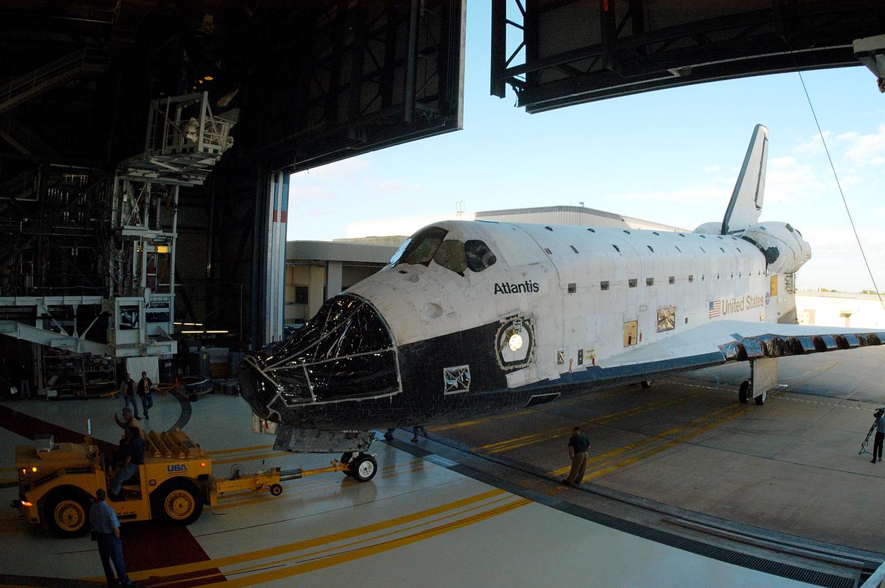 KENNEDY SPACE CENTER, FLA. -  The orbiter Atlantis rolls into the Orbiter Processing Facility after spending 10 days in the Vehicle Assembly Building.  The hiatus in the VAB allowed work to be performed in the OPF that can only be accomplished while the bay is empty. Work included annual validation of the bay's cranes, work platforms, lifting mechanisms and jack stands.  Work resumes to prepare Atlantis for launch in September 2004 on the first return-to-flight mission, STS-114.