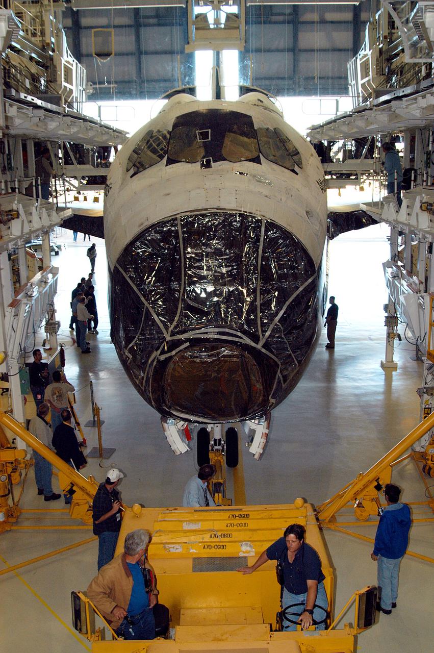 KENNEDY SPACE CENTER, FLA. -  The orbiter Atlantis is back inside the Orbiter Processing Facility after spending 10 days in the Vehicle Assembly Building.  The hiatus in the VAB allowed work to be performed in the OPF that can only be accomplished while the bay is empty. Work included annual validation of the bay's cranes, work platforms, lifting mechanisms and jack stands.  Work resumes to prepare Atlantis for launch in September 2004 on the first return-to-flight mission, STS-114.