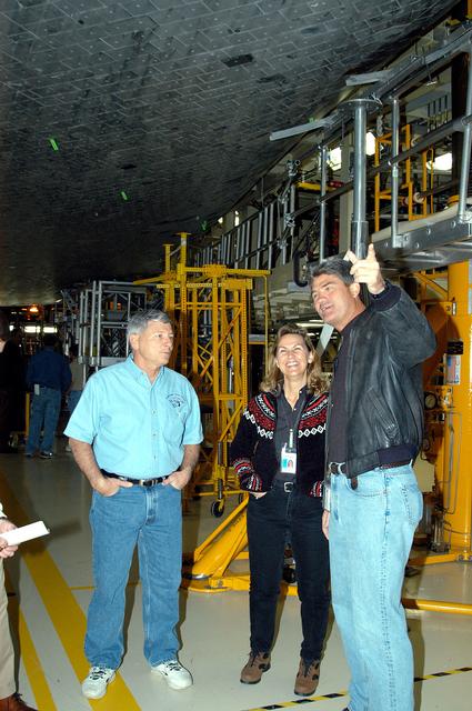 NASA image: KENNEDY SPACE CENTER, FLA. -- From left, NASA Deputy Associate Administrator for Space Station and Shuttle Programs Michael Kostelnik, United Space Alliance (USA) Director of Orbiter Operations Patty Stratton, and NASA Space Shuttle Program Manager William Parsons view the underside of Shuttle Discovery in Orbiter Processing Facility Bay 3.  NASA and USA Space Shuttle program management are participating in a leadership workday.  The day is intended to provide management with an in-depth, hands-on look at Shuttle processing activities at KSC.